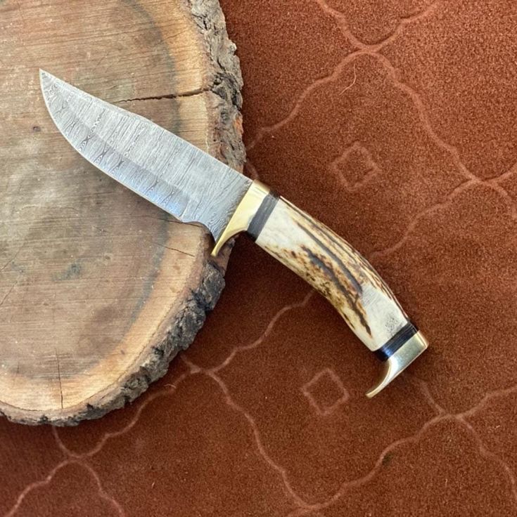 Close-up of antler horn handle and brass guards on Damascus knife