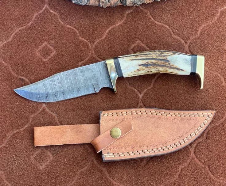 Handmade Damascus blade knife with brass guards and leather sheath