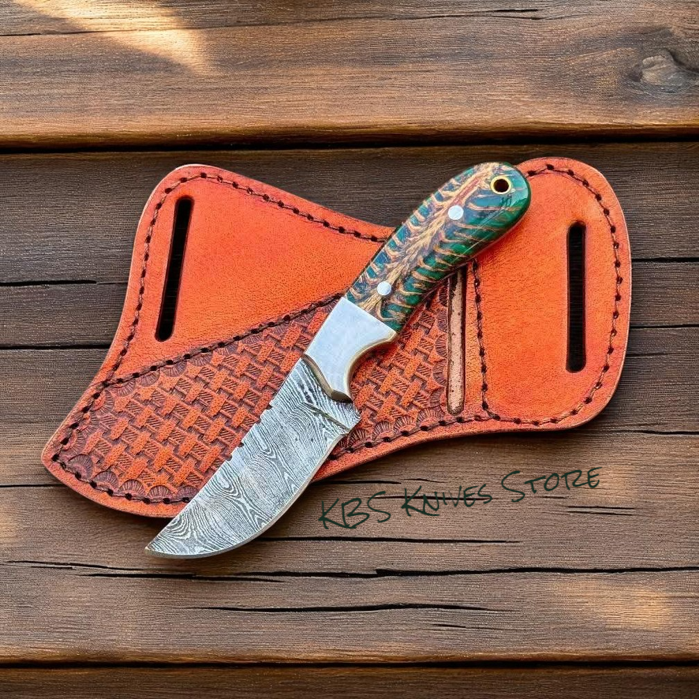 Custom 4 inch Damascus cowboy knife with horizontal leather sheath and pine cone resin handle