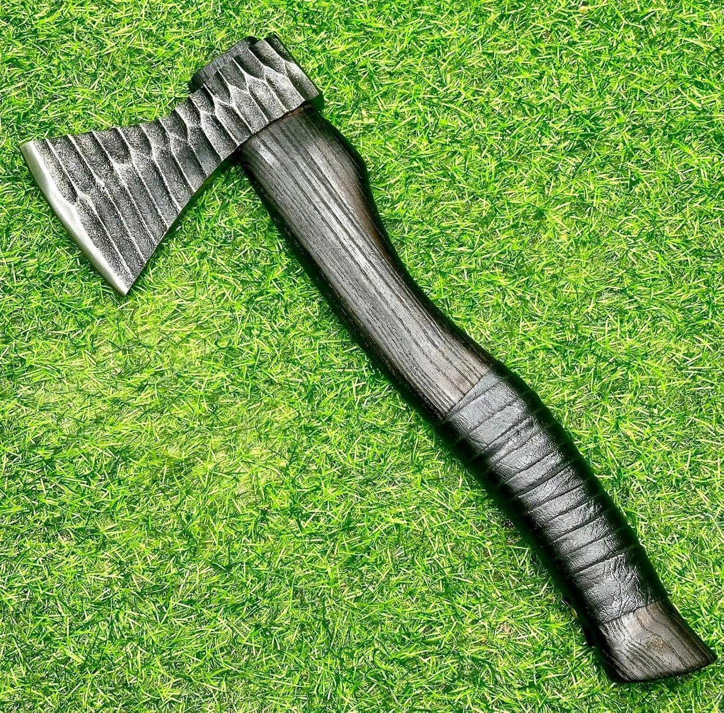 Functional Viking battle axe with a leather sheath, perfect for outdoor and everyday tasks