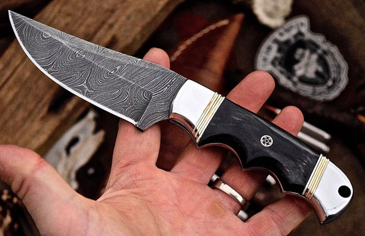 Custom handmade deer hunting knife with a Damascus steel blade.