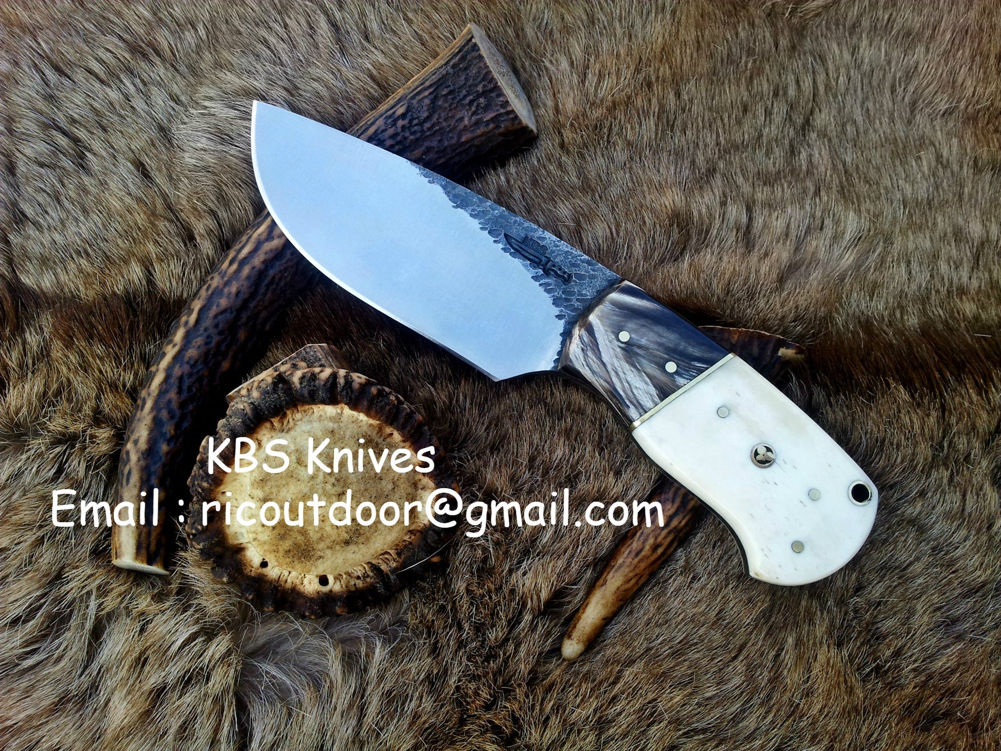 Custom 8-inch skinning knife with hand-forged 1095 steel blade and buffalo horn, camel bone handle.