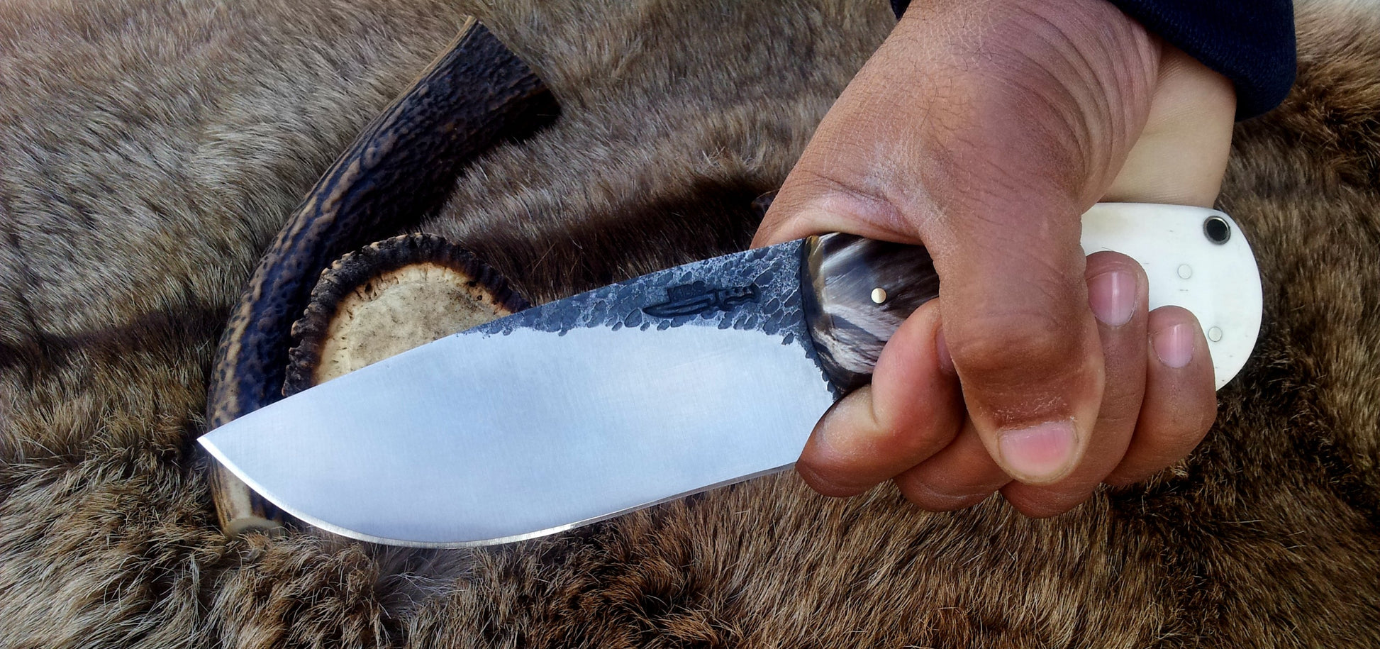 4-inch hand-forged 1095 steel blade on a custom hunting and skinning knife.