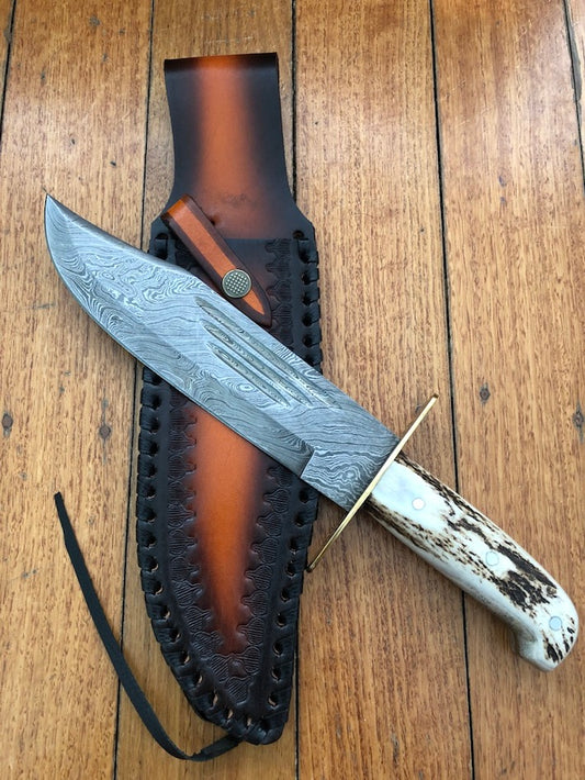 Custom handmade Western Bowie knife with 10-inch full tang Damascus steel blade and leather sheath.
