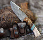 The Hunter's Edge - An 8.25-inch Gut Hook Skinning Hunting Knife featuring a Full Tang Raindrops Damascus Steel Blade, Rosewood and Epoxy Resin handle, complete with a leather sheath, available at KBS Knives Store for hunters and outdoor enthusiasts.