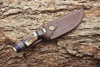 11-inch forged steel hunting knife with custom handle in a leather sheath
