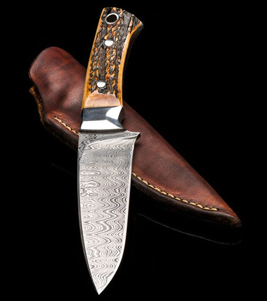 The Wilderness Elegance - An 8.5-inch hunting knife featuring a Full Tang Damascus Steel Blade, Antler Horn handle with Steel Bolster, and a leather sheath, available at KBS Knives Store for outdoor enthusiasts and hunters.