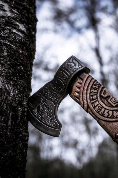 Handcrafted battle axe with roll-wrap leather grip and detailed blade engravings
