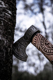 Handcrafted battle axe with roll-wrap leather grip and detailed blade engravings
