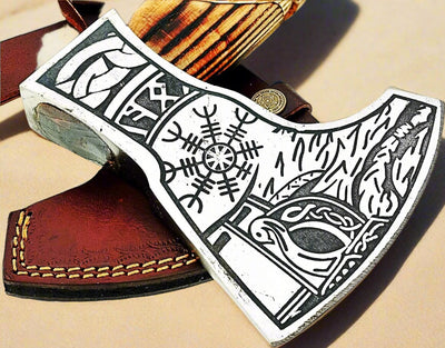 Side view of the Norse axe showing the detailed hand engraving on the handle and blade
