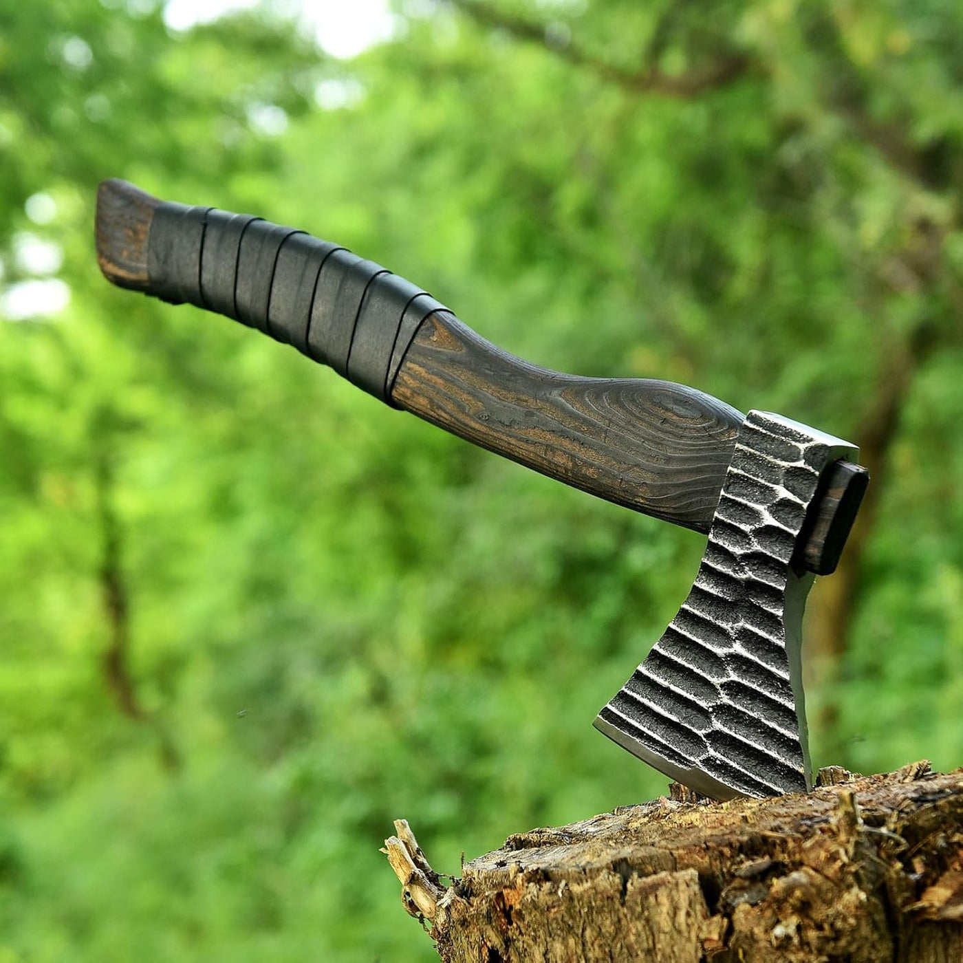 Viking battle axe with forged 1095 steel blade and ash wood handle wrapped in leather
