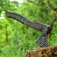 Viking battle axe with forged 1095 steel blade and ash wood handle wrapped in leather
