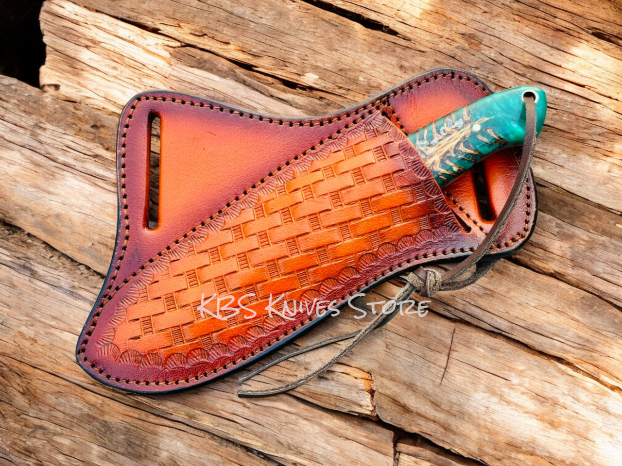 Leather knife sheath with a knife on a wooden surface, branded 'KBS Knives Store'.