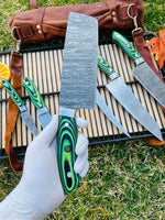 Damascus kitchen knife set displayed with wooden block for organized storage and presentation.