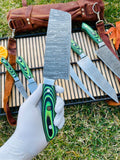 Damascus kitchen knife set displayed with wooden block for organized storage and presentation.