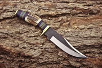 Handmade hunting knife with brass guard and leather sheath
