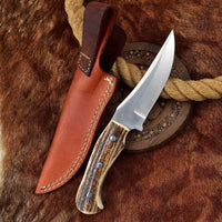 Custom handmade full tang D2 steel skinning knife with antler horn handle and leather sheath.
