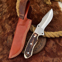 Custom handmade D2 steel skinning knife with antler horn handle and leather sheath.
