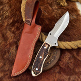 Custom handmade D2 steel skinning knife with antler horn handle and leather sheath.
