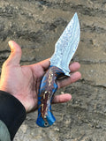 Pine-cone epoxy resin handle on a Damascus hunting knife
