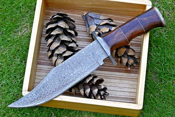 Hunting Bowie knife with Damascus steel blade, Rosewood handle with brass spacers, Damascus guard, and leather sheath. An essential tool for outdoor enthusiasts and hunters alike.
