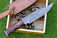 Hunting Bowie knife with Damascus steel blade, Rosewood handle with brass spacers, Damascus guard, and leather sheath. An essential tool for outdoor enthusiasts and hunters alike.