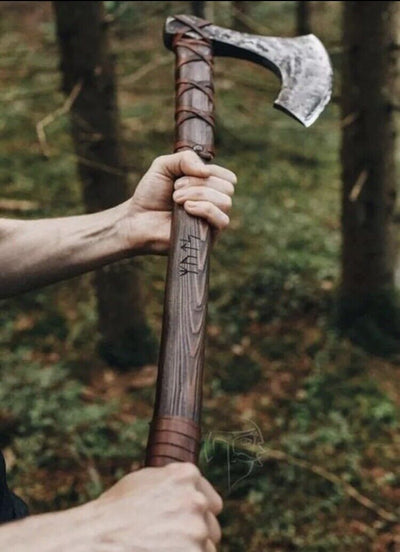 Detailed view of the rosewood handle wrapped in leather for enhanced grip
