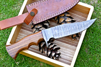 Hunting knife with Damascus steel blade, Rosewood handle, Damascus guard, and leather sheath. A versatile and elegant tool for outdoor exploration and wilderness pursuits.