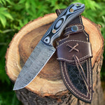 Hunting knife with Twist Damascus steel blade and Micarta G10 handle, presented with a leather sheath. An essential tool for outdoor exploration and wilderness survival.