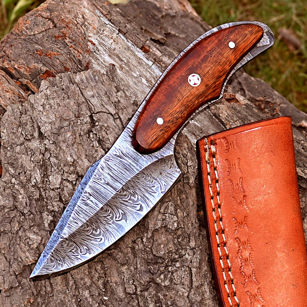 Skinning knife with Twist Damascus steel blade and Rosewood handle, presented with a leather sheath.