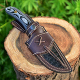 Hunting knife with Twist Damascus steel blade and Micarta G10 handle, presented with a leather sheath. An essential tool for outdoor exploration and wilderness survival.