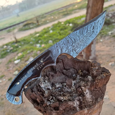 Custom handmade 8.5-inch Fire Damascus steel knife with leather sheath.
