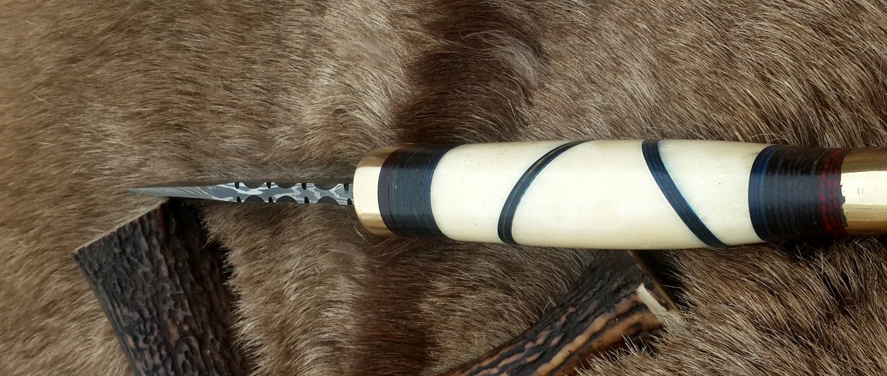 Unique hunting knife with camel bone handle and vibrant color sheets
