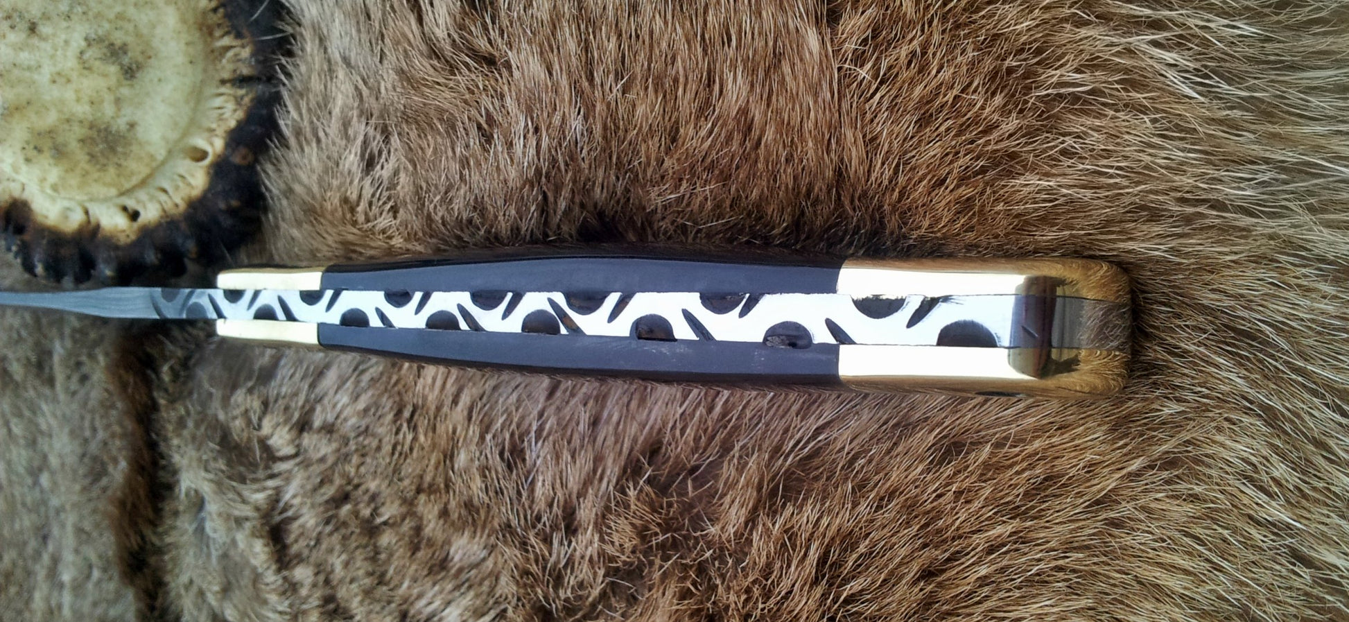 Durable fixed-blade hunting knife with leather sheath for safe transport
