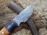 Close-up of the 3.25-inch drop point blade made from Damascus steel.
