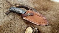 Premium handmade hunting knife with exotic wood handle for outdoor use
