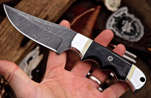 Custom handmade deer hunting knife with a Damascus steel blade.