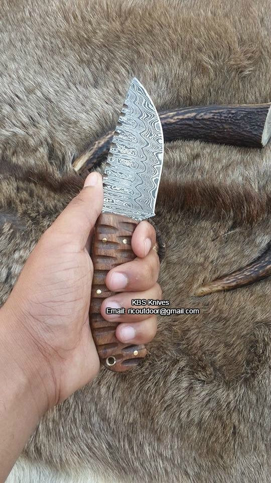 Close-up of the rosewood handle of the great skinning knife, showcasing its rich color and smooth finish.