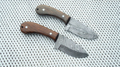 Close-up of the 3.25-inch Damascus steel blade showcasing its intricate patterns.
