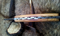 Olive wood handle of the gut hook knife, highlighting its comfort and grip.
