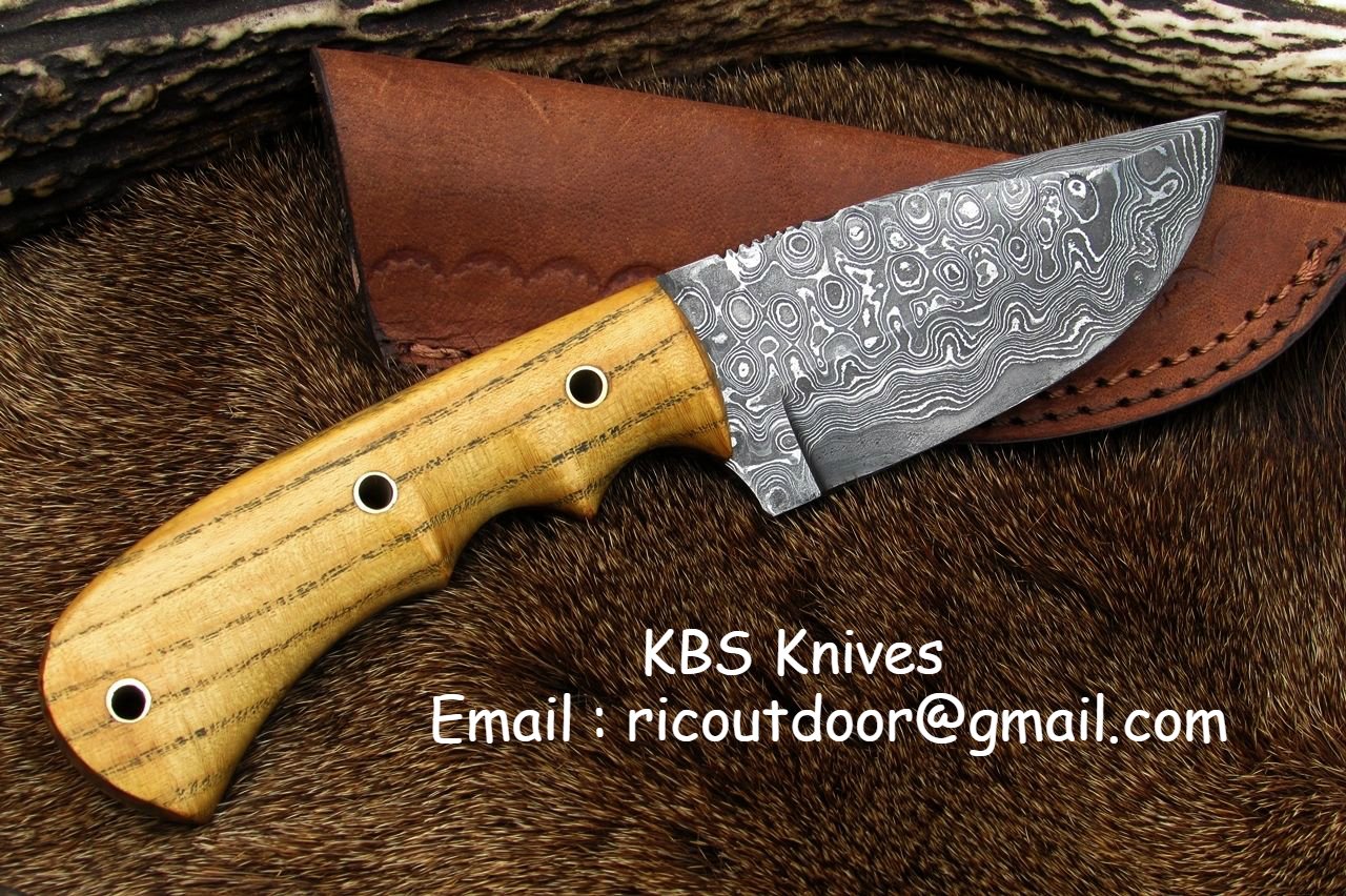 Best deer skinning knife displayed with its leather sheath for protection.