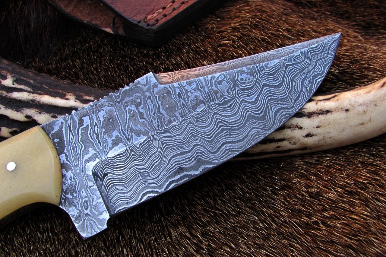Detailed view of the full tang Damascus steel blade on the Alaskan skinning knife.