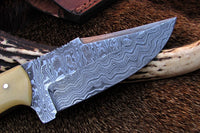 Detailed view of the full tang Damascus steel blade on the Alaskan skinning knife.