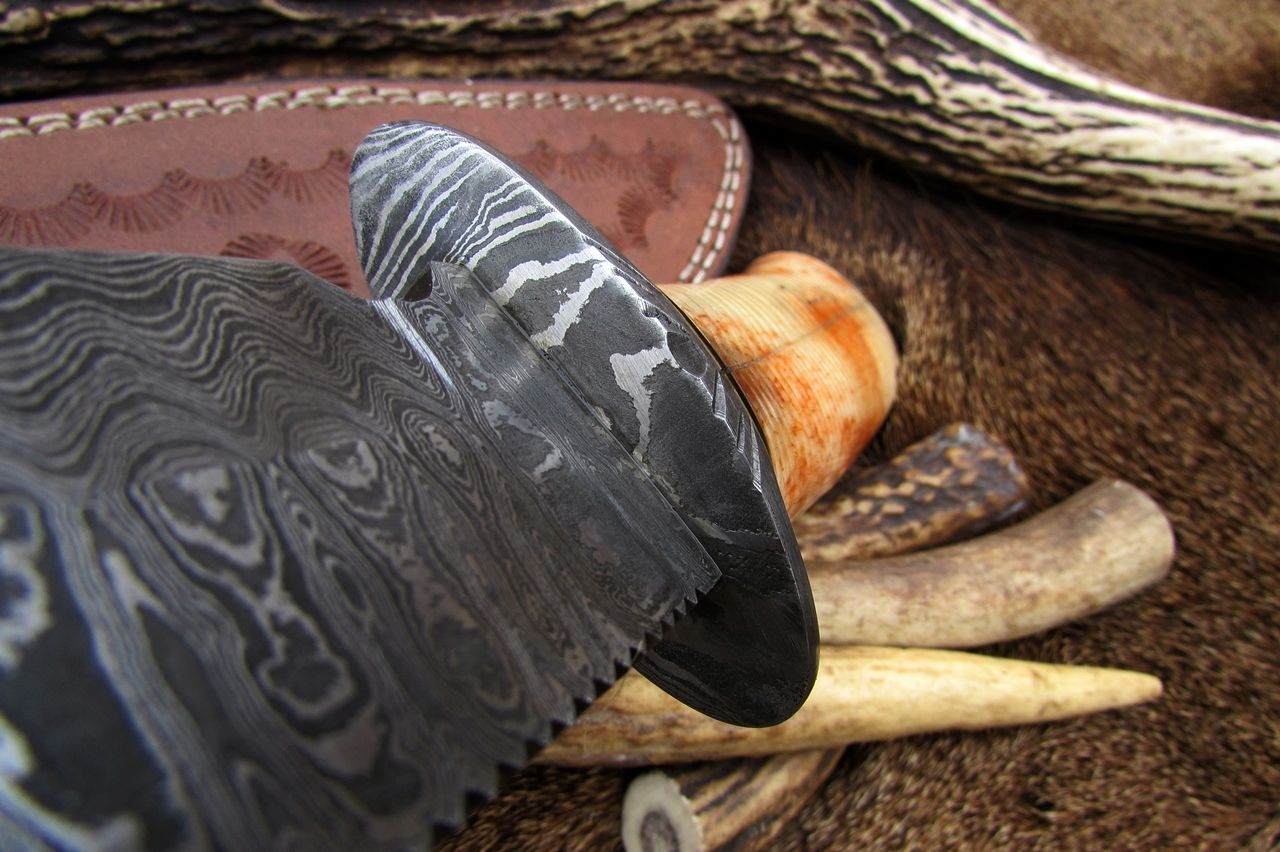 Colored camel bone handle on custom Damascus steel hunting knife
