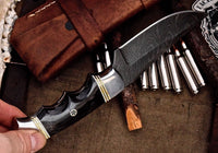 "Close-up of the Damascus steel blade displaying intricate patterns."





