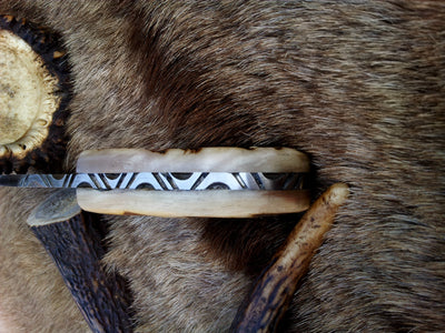 Close-up of the 3.75-inch Damascus steel blade showcasing its intricate patterns.
