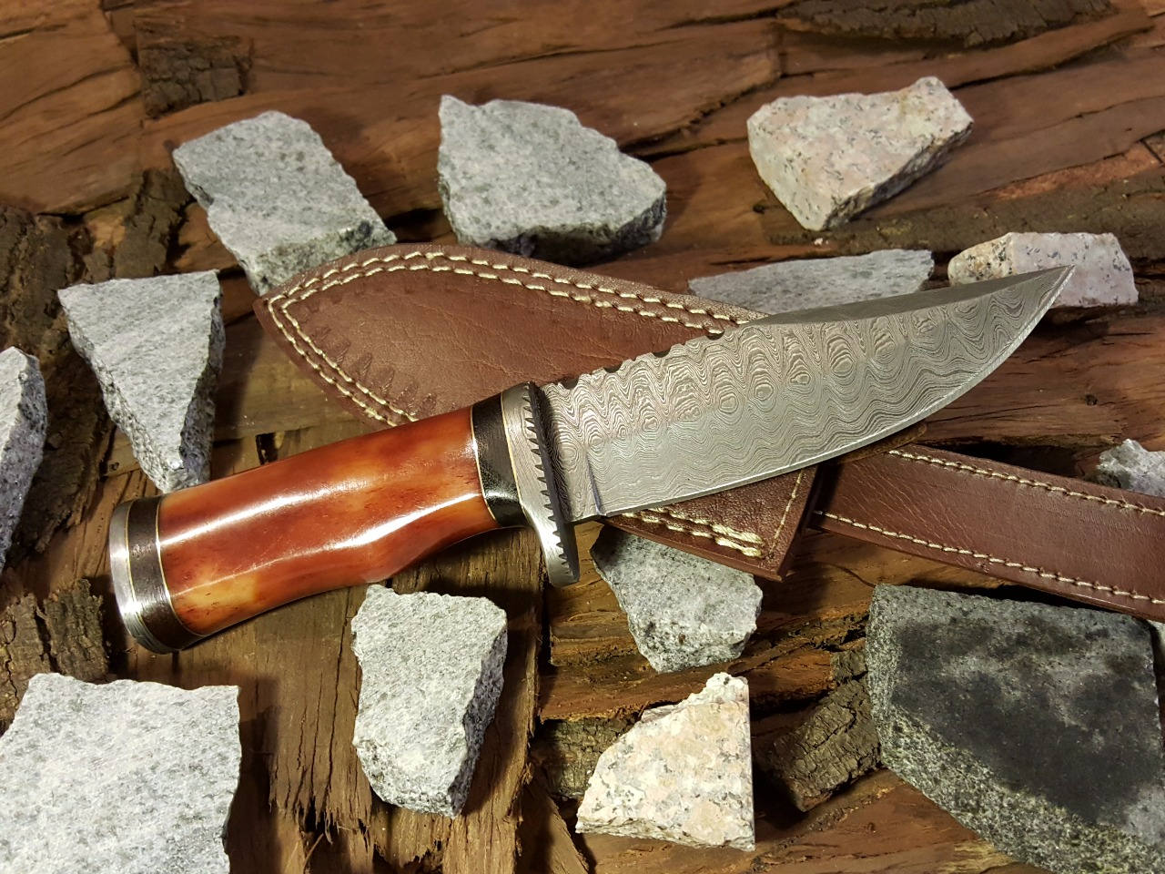 Overall view of the hunting knife with a leather sheath.