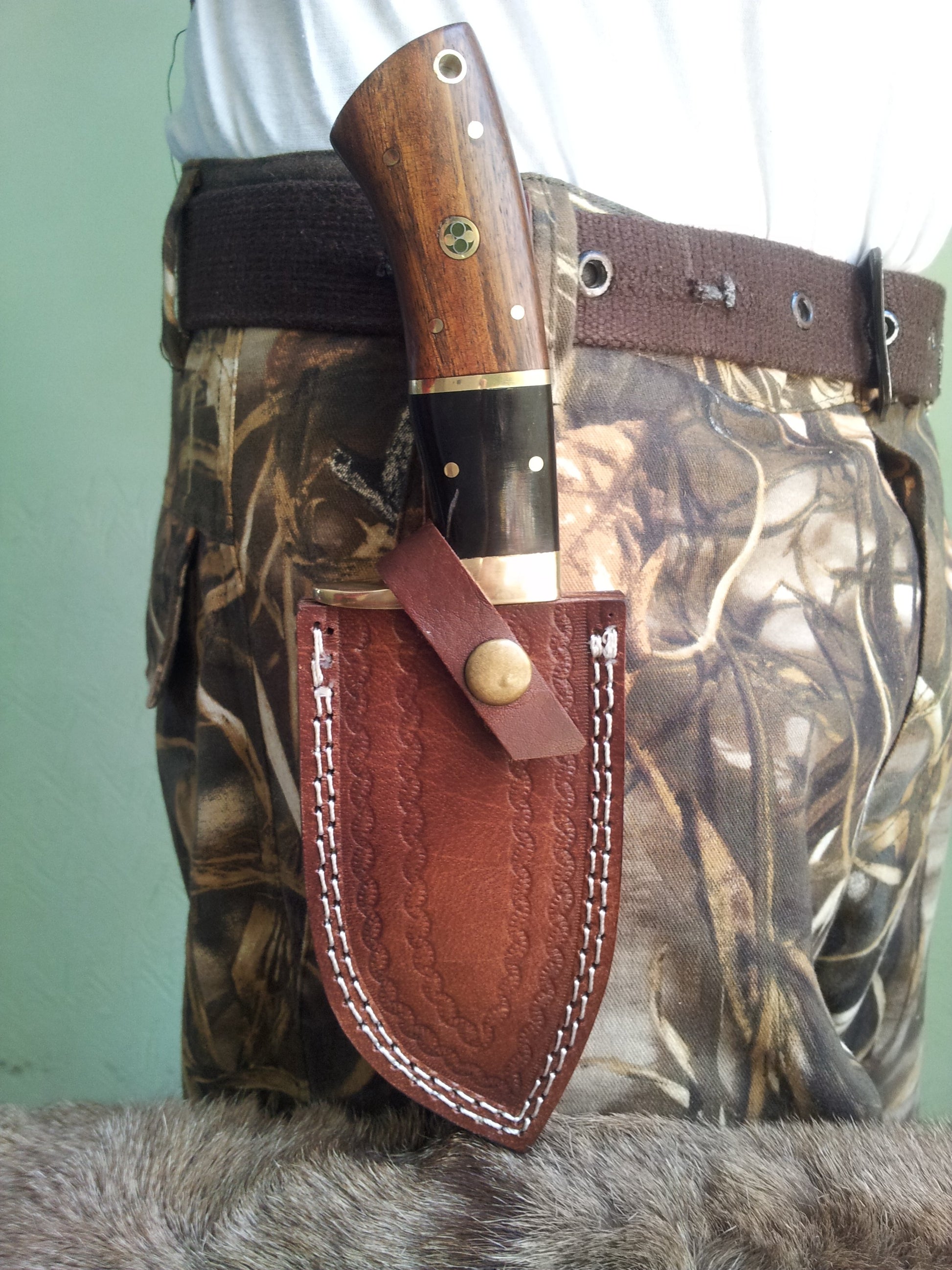 Close-up of the rosewood and buffalo horn handle with brass guard of the Fixed Blade Guthook knife
