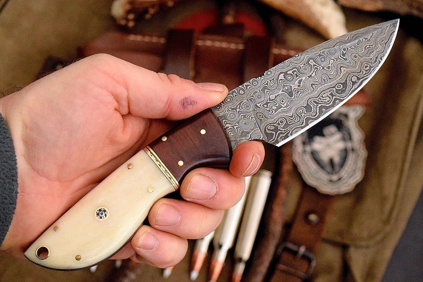 Custom handmade Damascus steel deer skinning knife with rosewood and bone handle.