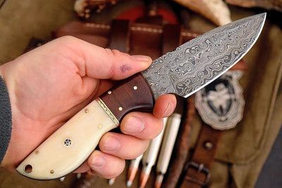 Custom handmade Damascus steel deer skinning knife with rosewood and bone handle.